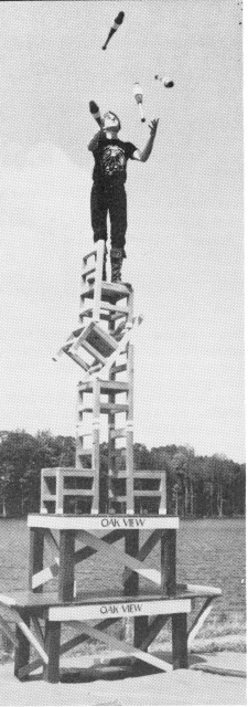 Juggling four clubs on a pile of stacked chairs is Scott Dineen, a performer with the Oak View Elementary School Exhibitional Activities Club in Fairfax, Virginia.