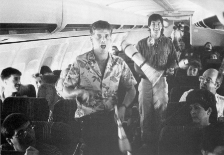 Mike Stilwell (front) and John Nations just can't stop. Juggling at 41,000 feet on way back east from San Jose. 