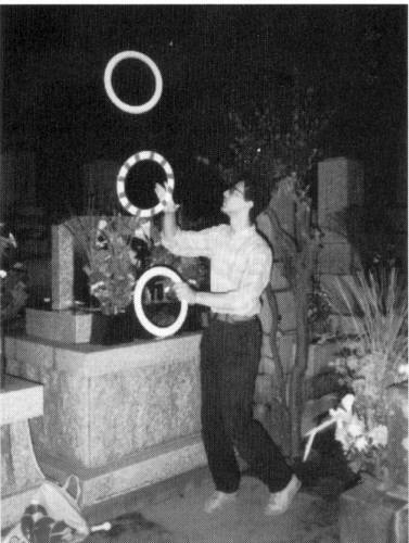 Dias juggling on the night of o-bon in the cemetery in front of the grave of his wife's grandmother-.  O-bon is a day in the middle of August when Japanese believe that the souls of the dearly departed return to Earth - like the Christian All Souls Day.  The atmosphere is quite festive as crowds flock to cemeteries with their paper lanterns, grave cleaning implements, incense, and food offerings.  In such an atmosphere he felt comfortable juggling for the soul of Izumi's kindly grandmother, "who had made me feel part of the family from the first time I met her."