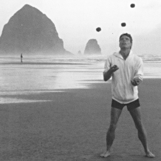 Richard Scott Morey juggling five in front of Haystack Rock on the Oregon coast.