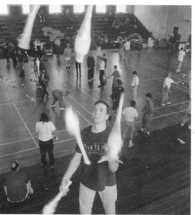 (Top Right) Charlie Peachock practices his 5 club cascade in the stands above the action in the Grady High School gym during the Groundhog Day festival (Bill Giduz photo)